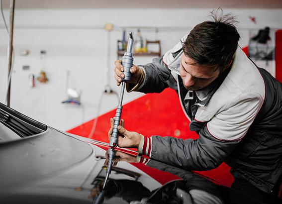 Auto Body Mechanic Disassembling Damaged Vehicle
